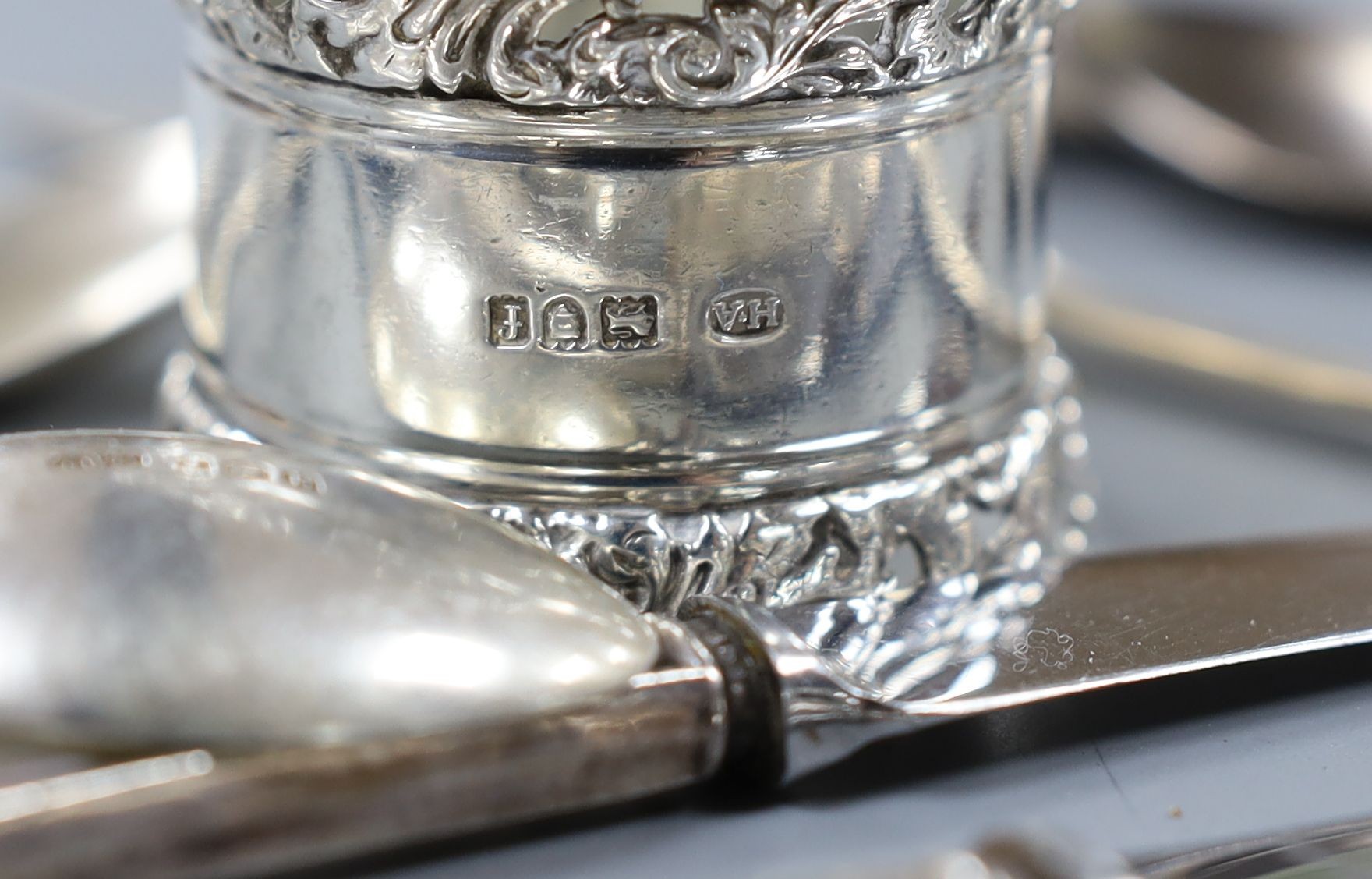 A quantity of small silver cutlery, a pair of silver decanter labels, Sherry and Whisky and eight various silver serviette rings.